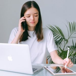 woman in white crew neck t shirt using silver macbook 3987034